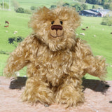 Robbie McFluff is a cute and quite little one of a kind artist bear in wildly curly mohair by Barbara-Ann Bears, he stands just 7 inches(18 cm) tall and is 5.5 inches (14 cm) sitting. Robbie is made from wonderful, wildly curly beige gold mohair, with a slightly warmer backcloth and he has beige German wool felt paw pads