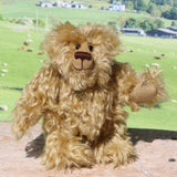 Robbie McFluff is a cute and quite little one of a kind artist bear in wildly curly mohair by Barbara-Ann Bears, he stands just 7 inches(18 cm) tall and is 5.5 inches (14 cm) sitting. Robbie is made from wonderful, wildly curly beige gold mohair, with a slightly warmer backcloth and he has beige German wool felt paw pads