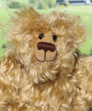 Robbie McFluff is a cute and quite little one of a kind artist bear in wildly curly mohair by Barbara-Ann Bears, he stands just 7 inches(18 cm) tall and is 5.5 inches (14 cm) sitting. Robbie is made from wonderful, wildly curly beige gold mohair, with a slightly warmer backcloth and he has beige German wool felt paw pads