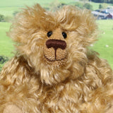 Robbie McFluff is a cute and quite little one of a kind artist bear in wildly curly mohair by Barbara-Ann Bears, he stands just 7 inches(18 cm) tall and is 5.5 inches (14 cm) sitting. Robbie is made from wonderful, wildly curly beige gold mohair, with a slightly warmer backcloth and he has beige German wool felt paw pads