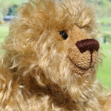Robbie McFluff is a cute and quite little one of a kind artist bear in wildly curly mohair by Barbara-Ann Bears, he stands just 7 inches(18 cm) tall and is 5.5 inches (14 cm) sitting. Robbie is made from wonderful, wildly curly beige gold mohair, with a slightly warmer backcloth and he has beige German wool felt paw pads