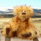 Rutherford is a sweet and very friendly, one of a kind, artist teddy bear in beautiful tipped mohair by Barbara-Ann Bears
Rutherford stands 9 inches/23 cm tall. 
Rutherford is made from long, dense, brown tipped gold mohair with brown German wool felt paw pads. He has beautiful hand painted, twinkling, glass eyes with hand coloured eyelids, a splendid nose embroidered from individual threads and a happy, hopeful expression