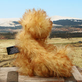 Rutherford is a sweet and very friendly, one of a kind, artist teddy bear in beautiful tipped mohair by Barbara-Ann Bears
Rutherford stands 9 inches/23 cm tall. 
Rutherford is made from long, dense, brown tipped gold mohair with brown German wool felt paw pads. He has beautiful hand painted, twinkling, glass eyes with hand coloured eyelids, a splendid nose embroidered from individual threads and a happy, hopeful expression