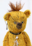 Scuggs is an endearingly sweet and gently wild beautifully coloured one of a kind, mohair artist bear by Barbara-Ann Bears, he stands 13 inches/33 cm tall and is 10.5 inches/26 cm sitting. He is made from gold mohair which has a dark brown backcloth, with a mohawk, hand dyed paw pads, and hand painted eyes with eyelids