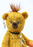 Scuggs is an endearingly sweet and gently wild beautifully coloured one of a kind, mohair artist bear by Barbara-Ann Bears, he stands 13 inches/33 cm tall and is 10.5 inches/26 cm sitting. He is made from gold mohair which has a dark brown backcloth, with a mohawk, hand dyed paw pads, and hand painted eyes with eyelids