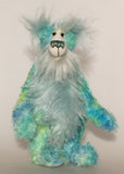 Sebastian Swoon is an elegant and beautifully coloured one of a kind, hand dyed mohair artist bear by Barbara-Ann Bears, he stands 14 inches/36 cm tall and is 10.5 inches/26 cm sitting.He is made from mohair hand dyed in shades of blue, green, turquoise and lime, His face, the fronts of his ears and the underside of his tail are made from a long, fluffy white faux fur and he has hand dyed velvet paws