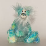 Sebastian Swoon is an elegant and beautifully coloured one of a kind, hand dyed mohair artist bear by Barbara-Ann Bears, he stands 14 inches/36 cm tall and is 10.5 inches/26 cm sitting.He is made from mohair hand dyed in shades of blue, green, turquoise and lime, His face, the fronts of his ears and the underside of his tail are made from a long, fluffy white faux fur and he has hand dyed velvet paws