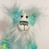 He is made from mohair hand dyed in shades of blue, green, turquoise and lime, His face, the fronts of his ears and the underside of his tail are made from a long, fluffy white faux fur and he has hand dyed velvet paws Sebastian Swoon has beautiful, hand painted eyes with hand coloured eyelids, a splendid nose embroidered from individual threads to complement his colouring and he has a sweet, friendly smile