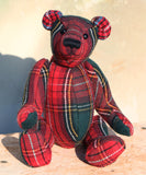 Plaid teddy bear on a wooden surface