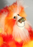Sunny is made from a beautiful faux fur in bright yellow, orange and red, his face the fronts of his ears and the underside of his tail are a long white fluffy mohair and he has bright gold wool felt paw pads. Sunny has beautiful hand painted glass eyes with eyelids, a wonderfully embroidered nose, sewn from individual threads to match his colouring and he has a huge beaming smile