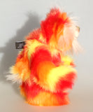 Sunny is a flamboyant, fun-loving and comical, one of a kind, artist bear by Barbara-Ann Bears in luxurious mohair and beautifully colourful faux fur and he stands 11.5 inches/29 cm tall and is 9 inches/23cm sitting.  Sunny is made from a beautiful faux fur in bright yellow, orange and red, his face the fronts of his ears and the underside of his tail are a long white fluffy mohair and he has bright gold wool felt paw pads