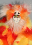 Sunny is a flamboyant, fun-loving and comical, one of a kind, artist bear by Barbara-Ann Bears in luxurious mohair and beautifully colourful faux fur and he stands 11.5 inches/29 cm tall and is 9 inches/23cm sitting.  Sunny is made from a beautiful faux fur in bright yellow, orange and red, his face the fronts of his ears and the underside of his tail are a long white fluffy mohair and he has bright gold wool felt paw pads