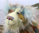 Close up of a colourful teddy bear with a textured fur pattern against a blurred natural background