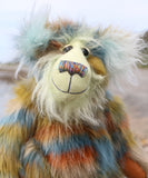 Close up of a colourful teddy bear with a textured fur pattern against a blurred natural background