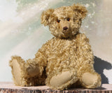 Walter is a large traditional one of a kind artist teddy bear in antique gold mohair by Barbara Ann Bears with an Edwardian collar he stands 21.5 inches/54cm tall. Walter has beige wool-felt paw pads, amber glass eyes, a neat hand embroidered nose and a sweet smile. Walter comes with an Edwardian style shirt collar and stud, but decided to take it off for this photo.