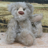 Wolfie sitting.
Wolfie is a wild and groovy guy, a veteran artist bear from Barbara-Ann Bears in silvery grey English mohair, he stands 10 inches/25 cm tall.