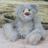 Wolfie sitting.
Wolfie is a wild and groovy guy, a veteran artist bear from Barbara-Ann Bears in silvery grey English mohair, he stands 10 inches/25 cm tall.