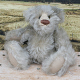 Wolfie sitting.
Wolfie is a wild and groovy guy, a veteran artist bear from Barbara-Ann Bears in silvery grey English mohair, he stands 10 inches/25 cm tall.