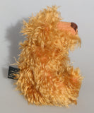 Plush teddy bear with curly fur on a grey background