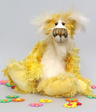Alfredo Buttercup, a comical yet elegant yellow and white, one of a kind artist teddy bear in stunning hand dyed mohair by Barbara-Ann Bears. Alfredo Buttercup stands 17 inches (43 cm) tall and is 13 inches (33 cm) sitting. He is mostly made from a long and straggly mohair hand-dyed in sunny shades of yellow and gold.