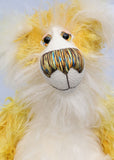 Alfredo Buttercup, a comical yet elegant yellow and white, one of a kind artist teddy bear in stunning hand dyed mohair by Barbara-Ann Bears. Alfredo Buttercup stands 17 inches (43 cm) tall and is 13 inches (33 cm) sitting. He is mostly made from a long and straggly mohair hand-dyed in sunny shades of yellow and gold.