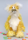 Alfredo Buttercup, a comical yet elegant yellow and white, one of a kind artist teddy bear in stunning hand dyed mohair by Barbara-Ann Bears. Alfredo Buttercup stands 17 inches (43 cm) tall and is 13 inches (33 cm) sitting. He is mostly made from a long and straggly mohair hand-dyed in sunny shades of yellow and gold.