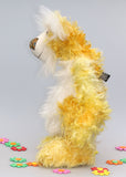 Alfredo Buttercup, a comical yet elegant yellow and white, one of a kind artist teddy bear in stunning hand dyed mohair by Barbara-Ann Bears. Alfredo Buttercup stands 17 inches (43 cm) tall and is 13 inches (33 cm) sitting. He is mostly made from a long and straggly mohair hand-dyed in sunny shades of yellow and gold.
