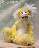Alfredo Buttercup, a comical yet elegant yellow and white, one of a kind artist teddy bear in stunning hand dyed mohair by Barbara-Ann Bears. Alfredo Buttercup stands 17 inches (43 cm) tall and is 13 inches (33 cm) sitting. He is mostly made from a long and straggly mohair hand-dyed in sunny shades of yellow and gold.