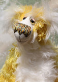 Alfredo Buttercup, a comical yet elegant yellow and white, one of a kind artist teddy bear in stunning hand dyed mohair by Barbara-Ann Bears. Alfredo Buttercup stands 17 inches (43 cm) tall and is 13 inches (33 cm) sitting. He is mostly made from a long and straggly mohair hand-dyed in sunny shades of yellow and gold.