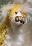 Alfredo Buttercup, a comical yet elegant yellow and white, one of a kind artist teddy bear in stunning hand dyed mohair by Barbara-Ann Bears. Alfredo Buttercup stands 17 inches (43 cm) tall and is 13 inches (33 cm) sitting. He is mostly made from a long and straggly mohair hand-dyed in sunny shades of yellow and gold.