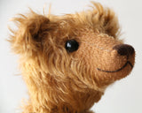 Ambrose is a charming, traditional one of a kind artist bear in German mohair by Barbara Ann Bears, he stands 10 inches/27 cm tall and is 7.5 inches/22 cm sitting. Ambrose is made from beautiful, slightly wavy, warm antique gold German mohair with fawn ultrasuede paw pads and vintage boot buttons for eyes