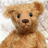 Ambrose is a charming, traditional one of a kind artist bear in German mohair by Barbara Ann Bears, he stands 10 inches/27 cm tall and is 7.5 inches/22 cm sitting. Ambrose is made from beautiful, slightly wavy, warm antique gold German mohair with fawn ultrasuede paw pads and vintage boot buttons for eyes