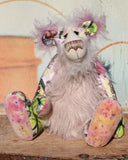 Amelie Papillion is an extremely beautiful, one of a kind artist bear by Barbara-Ann Bears, she stands 17.5 inches (44 cm) tall and is 12 inches (30 cm) sitting. Amelie Papillion is made from the most wonderful printed fabric, with areas of white, grey and pink and on top of this a myriad of fluttering butterflies