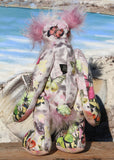 Amelie Papillion is an extremely beautiful, one of a kind artist bear by Barbara-Ann Bears, she stands 17.5 inches (44 cm) tall and is 12 inches (30 cm) sitting. Amelie Papillion is made from the most wonderful printed fabric, with areas of white, grey and pink and on top of this a myriad of fluttering butterflies