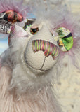 Amelie Papillion is an extremely beautiful, one of a kind artist bear by Barbara-Ann Bears, she stands 17.5 inches (44 cm) tall and is 12 inches (30 cm) sitting. Amelie Papillion is made from the most wonderful printed fabric, with areas of white, grey and pink and on top of this a myriad of fluttering butterflies