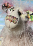 Amelie Papillion is an extremely beautiful, one of a kind artist bear by Barbara-Ann Bears, she stands 17.5 inches (44 cm) tall and is 12 inches (30 cm) sitting. Amelie Papillion is made from the most wonderful printed fabric, with areas of white, grey and pink and on top of this a myriad of fluttering butterflies