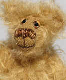 Amos has small hand painted glass eyes with eyelids, he has a pert little nose embroidered from several shades of beige and brown perle cotton and a beaming smile