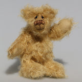 Amos is a very sweet and happy little artist bear by Barbara Ann Bears, he stands just 6.5 inches/16 cm tall and is 5 inches/12 cm sitting. He is made from a very long and fluffy beige mohair with beige wool felt paw pads, hand painted glass eyes with eyelids, a little hand embroidered nose and a beaming smile