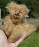 Amos is a very sweet and happy little artist bear by Barbara Ann Bears, he stands just 6.5 inches/16 cm tall and is 5 inches/12 cm sitting. He is made from a very long and fluffy beige mohair with beige wool felt paw pads, hand painted glass eyes with eyelids, a little hand embroidered nose and a beaming smile