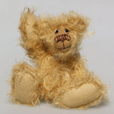 Amos is a very sweet and happy little artist bear by Barbara Ann Bears, he stands just 6.5 inches/16 cm tall and is 5 inches/12 cm sitting. He is made from a very long and fluffy beige mohair with beige wool felt paw pads, hand painted glass eyes with eyelids, a little hand embroidered nose and a beaming smile