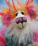 Anoushka Flambé a joyous celebration of colourful happiness, a one of a kind artist bear in hand dyed mohair & faux fur by Barbara-Ann Bears. Anoushka Flambé stands 10 inches( 25 cm) tall and is 7.5 inches ( 19 cm) sitting, this doesn't include her flaming hair which adds another 2.5 inches (7cm).