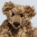 Bernard McFluff is made from a beautiful, distressed, shaggy, soft brown English mohair. He has black Austrian glass, spherical eyes, these catch the light from any angle so he always has a cheeky twinkle in his eye. Bernard McFluff has a neatly sewn nose and a sweet smile.