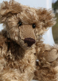 Bernard McFluff is made from a beautiful, distressed, shaggy, soft brown English mohair. He has black Austrian glass, spherical eyes, these catch the light from any angle so he always has a cheeky twinkle in his eye. Bernard McFluff has a neatly sewn nose and a sweet smile.