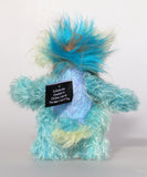 Bim-Bam is made from several different mohairs, he's mainly a medium length, slightly distressed and sparse mohair hand dyed a beautiful aqua, his tummy is a slightly longer, dense mohair hand dyed in silver, with hints of blue and purple, his back is shorter, sparse mohair dyed sky blue and his face, the fronts of his ears and the underside of his tail are a longer, fluffy mohair hand-dyed a light, happy yellow. The top of his head is a plume of aqua faux fur. Bim-Bam has hand dyed velvet paw pads