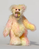 Blossom is a sweet and gently colourful, one of a kind mohair artist bear by Barbara-Ann Bears, she stands 10 inches/25 cm tall and is 8 inches/20 cm sitting. Blossom is made from medium length wildly curly mohair that Barbara has hand dyed a soft primrose yellow and delicate pink with matching hand dyed velvet paw pads