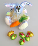 Bluebell is a small and sweet, one of a kind rabbit in beautifully coloured mohair and designer bunny fabric by Barbara Ann Bears, she stands just 5 inches/13 cm tall.  Bluebell is mostly made from a beautiful 'Peter Rabbit' cotton fabric with hand dyed blue and pale yellow mohair and hand dyed velvet paws with her carrot and Easer eggs