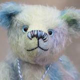 Bluey is made from a fairly short and sparse German mohair which Barbara has hand-dyed in natural blues, there are muted shades of aqua, jade, lilac and turquoise . Bluey has coordinating velvet paw pads which were hand-dyed with his mohair.  Bluey has glass eyes which were painted to match his mohair, a cute little nose carefully embroidered with individual threads to also match his colouring and a content and appealing expression.