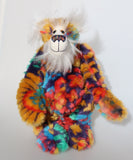 Bosworth Bloom is a very handsome and beautifully coloured one of a kind artist bear, he stands 15.5 inches/39 cm tall and is 12 inches (30 cm) sitting. Bosworth Bloom is made from a stunning piece of faux fur with a navy backing with floral motifs in gold, jade, cyan and red, and a very long and fluffy white mohair used for his face, ears and tail