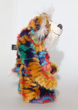 Bosworth Bloom is a very handsome and beautifully coloured one of a kind artist bear, he stands 15.5 inches/39 cm tall and is 12 inches (30 cm) sitting. Bosworth Bloom is made from a stunning piece of faux fur with a navy backing with floral motifs in gold, jade, cyan and red, and a very long and fluffy white mohair used for his face, ears and tail