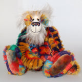 Bosworth Bloom is a very handsome and beautifully coloured one of a kind artist bear, he stands 15.5 inches/39 cm tall and is 12 inches (30 cm) sitting. Bosworth Bloom is made from a stunning piece of faux fur with a navy backing with floral motifs in gold, jade, cyan and red, and a very long and fluffy white mohair used for his face, ears and tail